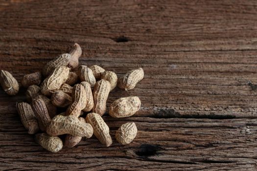 Peanuts on a wooden background. Top view.