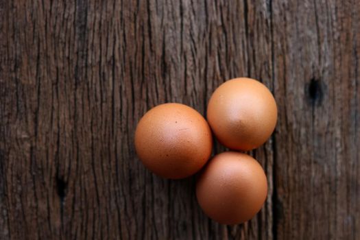 Hen eggs on wood background. Top View.