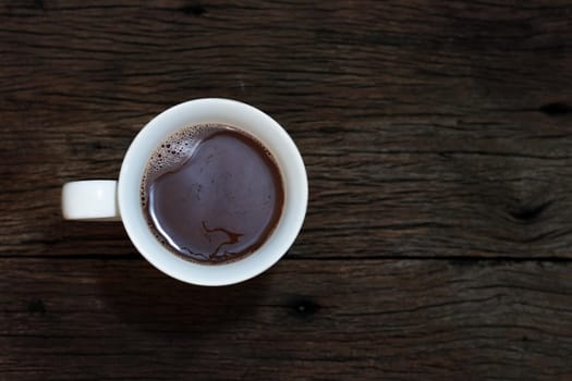 Coffee on wood background top view.