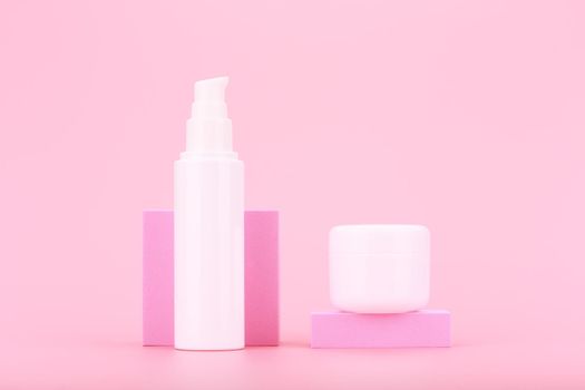 Face cream or lotion and under eye gel or cream against pink background. Concept of daily skin care, moisturizing and hydrating beauty products. 