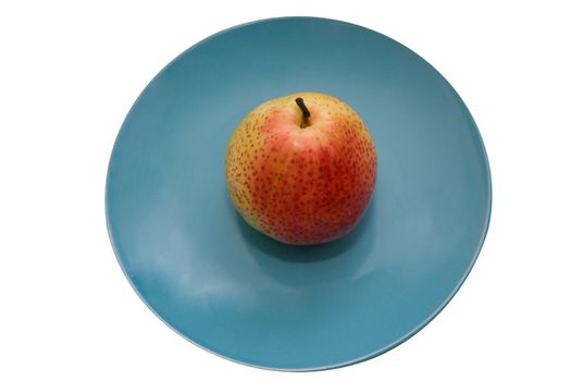 Juicy pear on a blue ceramic plate isolate on white background