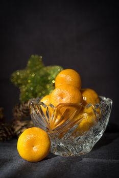 Christmas and new year background with tangerines and artificial Christmas tree