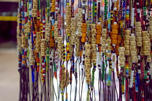 Bracelets with beads and letters on the shop window.