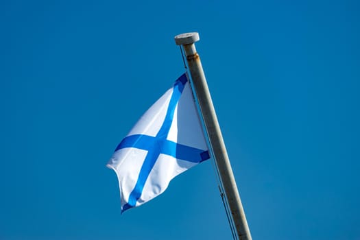 Vladivostok, Russia. Naval flag on blue sky background
