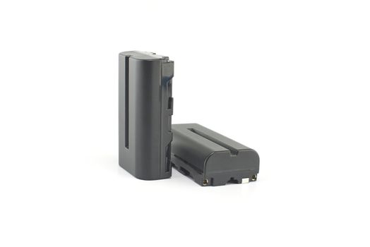 Two NP-F type rechargeable batteries isolated on a white background, electronics and camera equipment