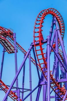 close-up image of a rollercoaster track and the blue sky