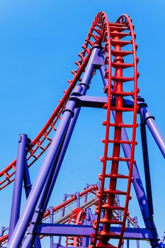 close-up image of a rollercoaster track and the blue sky