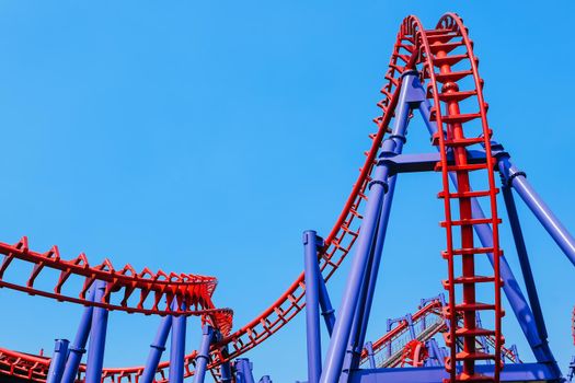 close-up image of a rollercoaster track and the blue sky