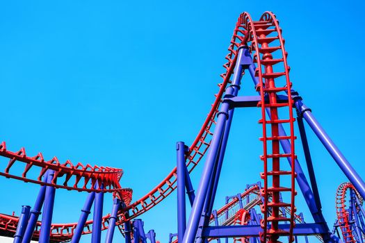 close-up image of a rollercoaster track and the blue sky