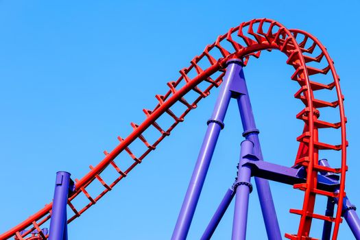 close-up image of a rollercoaster track and the blue sky