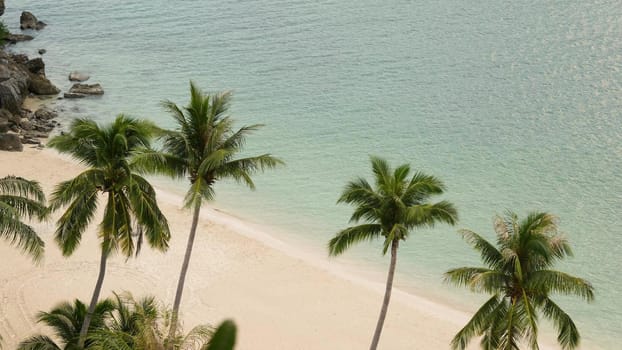 Calm sea near green jungle. Peaceful ocean with turquoise water, white sandy tropical shore in Ang Thong paradise national park, Thailand. Rainforest and rocks. Dream beach, relax and holiday concept.