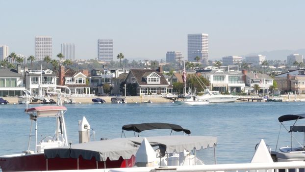 Newport beach harbor, weekend marina resort with yachts and sailboats, Pacific Coast, California, USA. Waterfront luxury suburb real estate in Orange County. Expensive beachfront holiday destination.