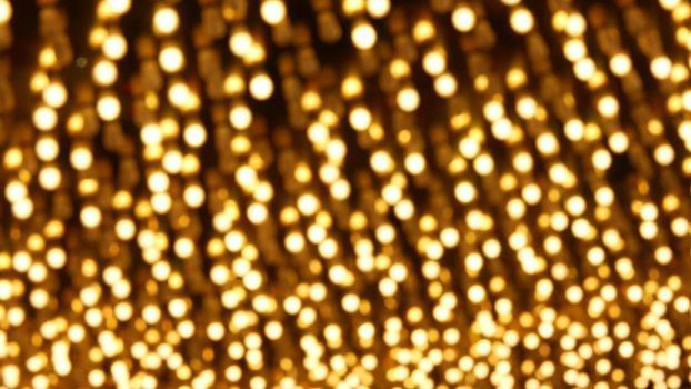 Defocused old fasioned electric lamps glowing at night. Abstract close up of blurred retro casino decoration shimmering, Las Vegas USA. Illuminated vintage style bulbs glittering on Freemont street.
