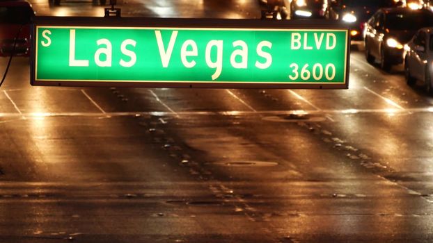 Fabulos Las Vegas, traffic sign glowing on The Strip in sin city of USA. Iconic signboard on the road to Fremont street in Nevada. Illuminated symbol of casino money playing and bets in gaming area.