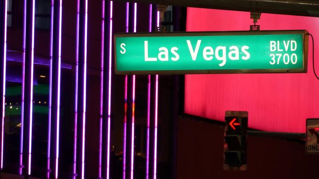Fabulos Las Vegas, traffic sign glowing on The Strip in sin city of USA. Iconic signboard on the road to Fremont street in Nevada. Illuminated symbol of casino money playing and bets in gaming area.