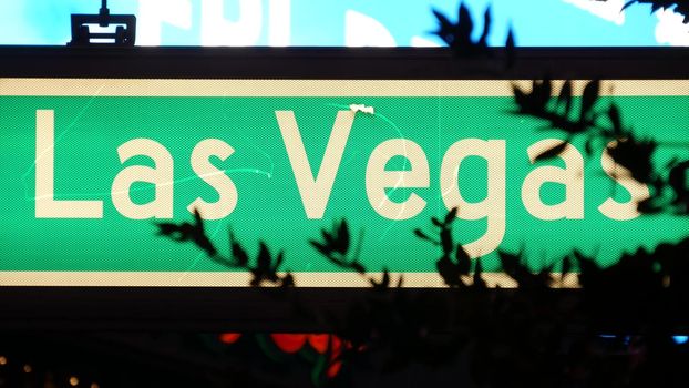 Fabulos Las Vegas, traffic sign glowing on The Strip in sin city of USA. Iconic signboard on the road to Fremont street in Nevada. Illuminated symbol of casino money playing and bets in gaming area.