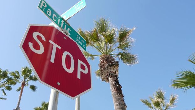 Pacific street road sign on crossroad, route 101 tourist destination, California, USA. Lettering on intersection signpost, symbol of summertime travel and vacations.Signboard in city near Los Angeles.