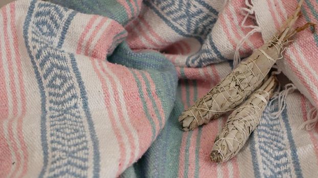 Dried white sage smudge stick, relaxation and aromatherapy. Smudging during psychic occult ceremony, herbal healing, yoga or aura cleaning. Essential incense for esoteric rituals and fortune telling.