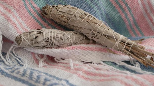 Dried white sage smudge stick, relaxation and aromatherapy. Smudging during psychic occult ceremony, herbal healing, yoga or aura cleaning. Essential incense for esoteric rituals and fortune telling.