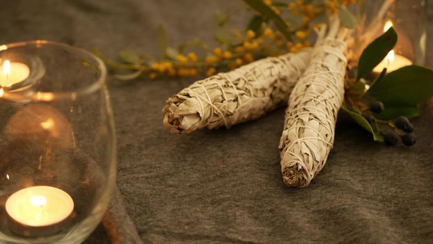 Dried white sage smudge stick, relaxation and aromatherapy. Smudging during psychic occult ceremony, herbal healing, yoga or aura cleaning. Essential incense for esoteric rituals and fortune telling.