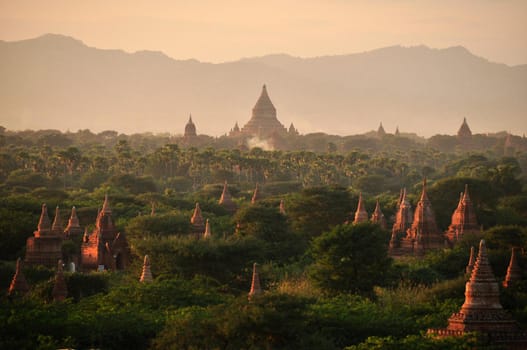 Green land with spears of temple, Picturesque landscape of green spacious terrain with spires of oriental pagodas and paya, Myanmar, Bagan. Mingalazedi Sulamani Shwezigon Ananda Htilominlo