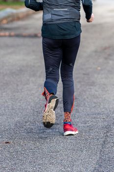 particular of woman running in the park early in the morning