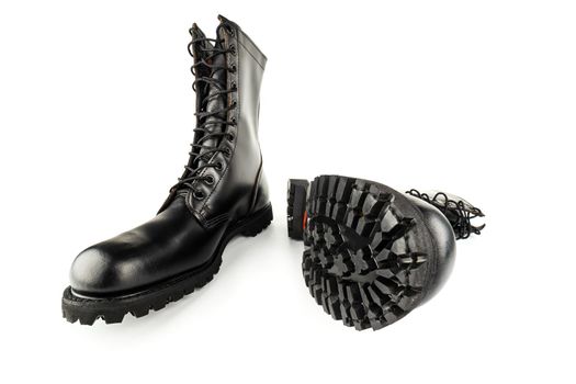 pair of black leather 10-inch new black military combat lug sole ankle jump boots, isolated on white background