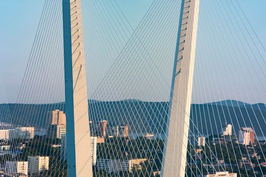 Vladivostok, Russia. Golden bridge is a landmark of the city at sunset.