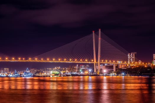 Vladivostok, Russia. Night landscape with views of the Golden bridge and ships.