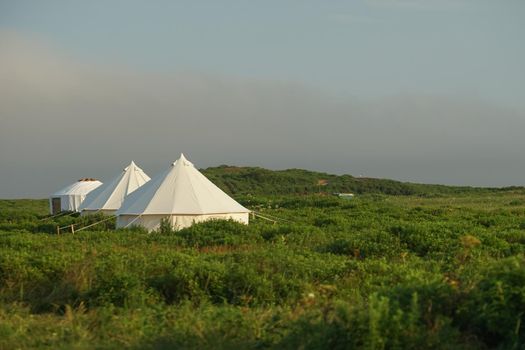 White tent on the background of the natural landscape. Travel and tourism.
