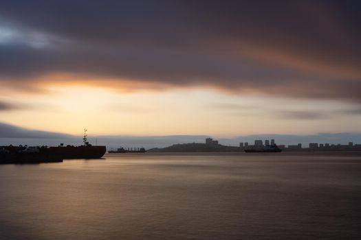 Seascape at sunset on the background of the coastline of Vladivostok, Russia