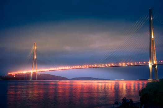 Vladivostok, Russian bridge. Night photos on a long exposure. Beautiful reflection on the surface of the sea.