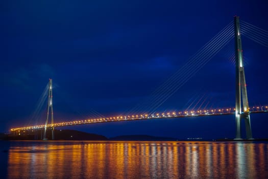 Vladivostok, Russian bridge. Night photos on a long exposure. Beautiful reflection on the surface of the sea.