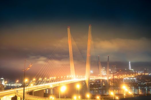 Vladivostok, Russia. Night landscape with a view of the Golden bridge.