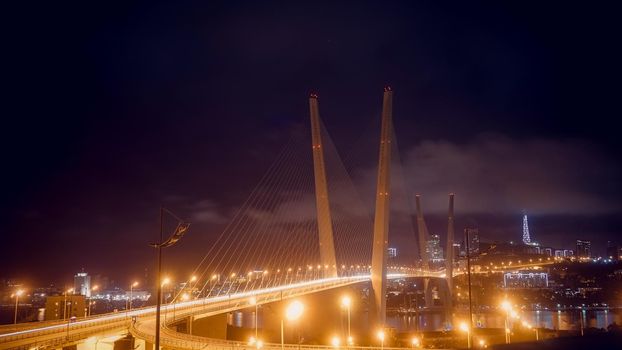 Vladivostok, Russia. Night landscape with a view of the Golden bridge.