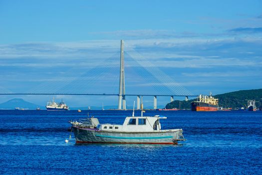 Marine landscape with views of the Russian ships and the bridge. Vladivostok, Russia