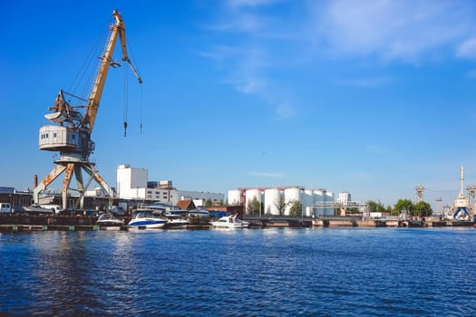 Kaliningrad , Russia. Port of a large Russian city with ships and various equipment on the background of the river.