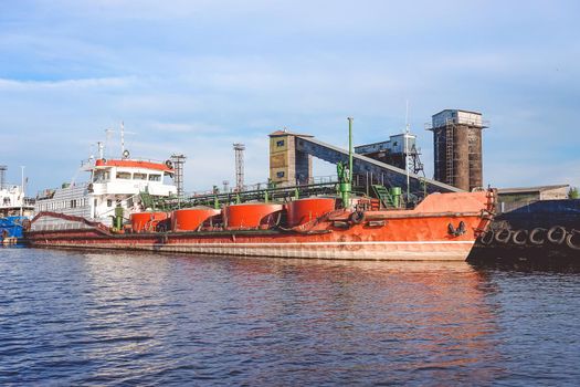Kaliningrad , Russia. Port of a large Russian city with ships and various equipment on the background of the river.