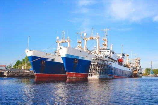 Kaliningrad , Russia. Port of a large Russian city with ships and various equipment on the background of the river.
