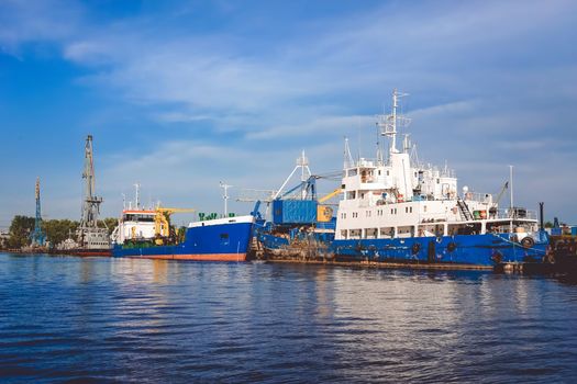 Kaliningrad , Russia. Port of a large Russian city with ships and various equipment on the background of the river.