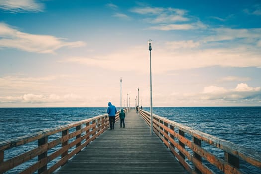 Zelenogradsk, Russia. Seascape overlooking the long pier of the resort town with walking people.