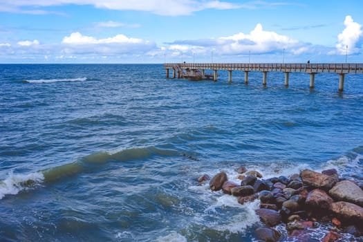 Zelenogradsk, Russia. Seascape overlooking the long pier of the resort town with walking people.