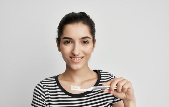 woman in striped t-shirt toothbrush dental health hygiene. High quality photo