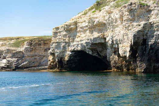 Beautiful view of us we are with the rocky shore of the black sea and the green-blue water on a Sunny summer cloudless day. Tarkhankut national reserve. Republic Of Crimea