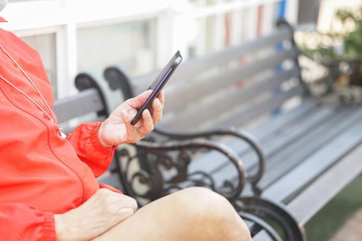 asian old elder senior man elderly male using mobile smart phone cellphone outdoor. mature retirement lifestyle