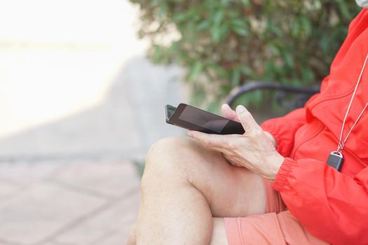 asian old elder senior man elderly male using mobile smart phone cellphone outdoor. mature retirement lifestyle