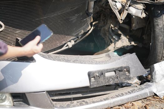 hand take photo of crashed damaged broken car. automobile crash collision accident