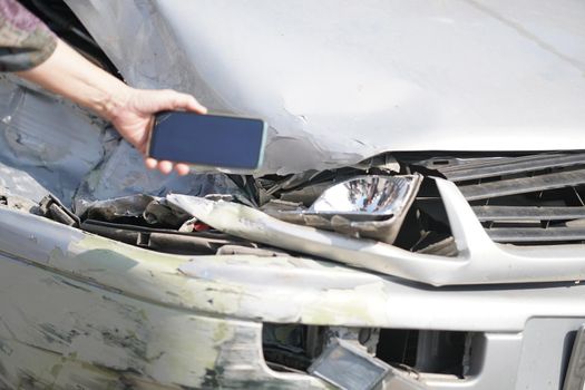 hand take photo of crashed damaged broken car. automobile crash collision accident