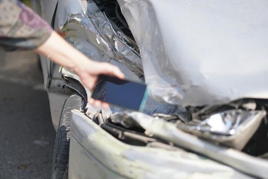 hand take photo of crashed damaged broken car. automobile crash collision accident