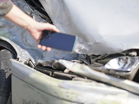 hand take photo of crashed damaged broken car. automobile crash collision accident